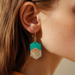 Woman wearing teal, walnut, and gold geometric drop earrings from Studio Kempster, showing scale and style.