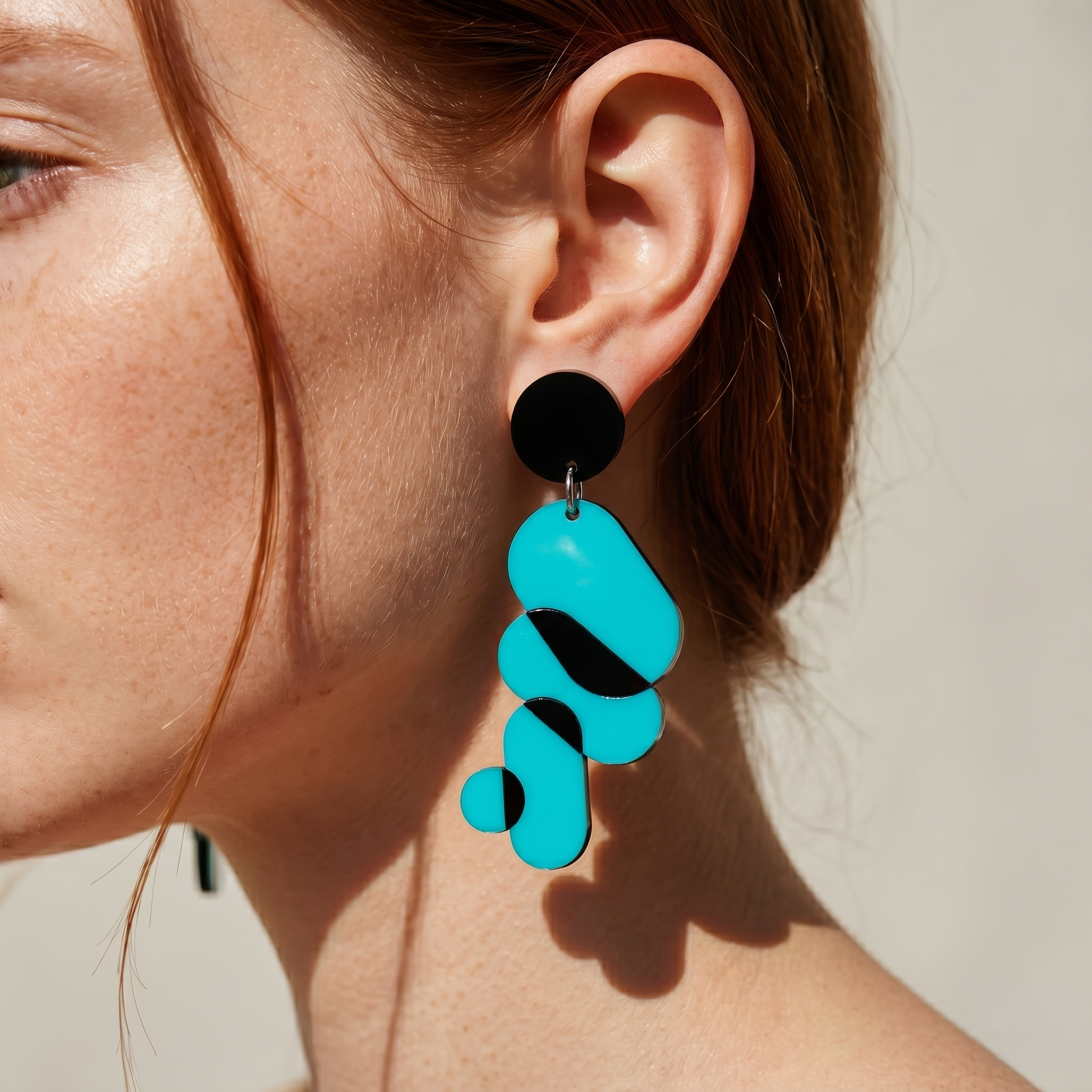 Model wearing teal Link Earrings 